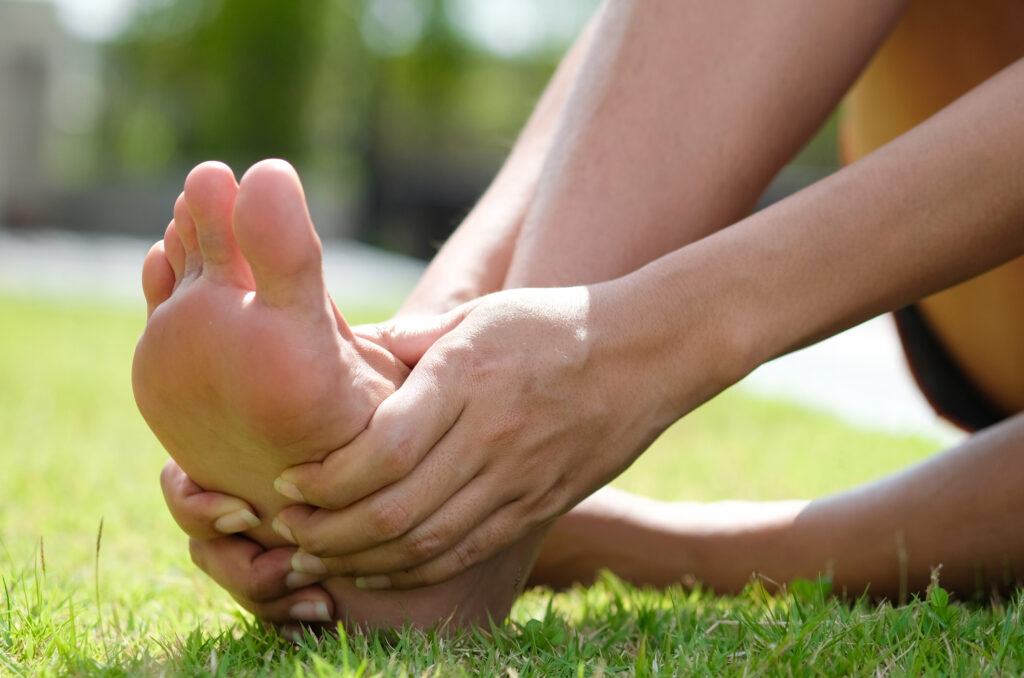 Woman with neuropathy holding her foot